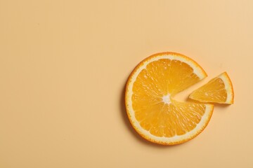 Slices of juicy orange on beige background, flat lay. Space for text