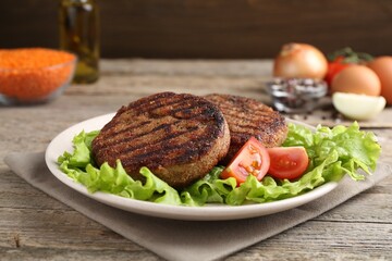 Vegetarian product. Tasty lentil cutlets served on wooden table