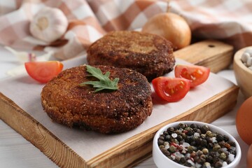 Vegetarian product. Tasty bean cutlets served on white wooden table, closeup