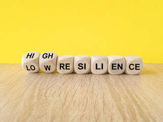 High or low resilience symbol. Turned wooden cubes and changes words 'low resilience' to 'high...