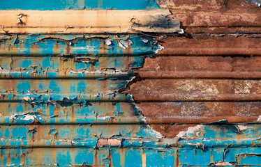 pattern rusty metal surface with remnants of blue and yellow paint paint