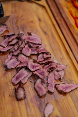 Cut perfect juicy steak peaces on wooden cutboard during cooking out time