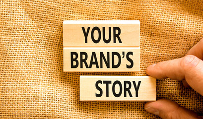 Branding and your brand story symbol. Concept words Your brands story on beautiful wooden blocks. Beautiful canvas background. Businessman hand. Business branding your brand story concept. Copy space. - obrazy, fototapety, plakaty