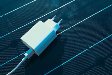 Mobile Phone Chargers on Photovoltaic sells. Concept of sustainable lifestyle and green renewable energy. green sustainable of solar and windmill energy produced from renewable resources