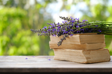 bouquet of wild flowers on old wooden table in garden, beautiful blurred natural landscape in...