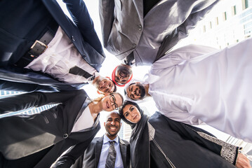 International corporate business team portait - Multiethnic group of business people smiling and looking down at camera in Dubai