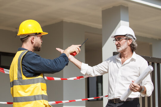 Businessman talking with a contractor.