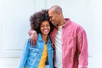 African american couple of lovers portrait, man is hugging his girlfriend and smiling