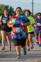 A competitive race with a diverse group of individuals running towards a finish line with determination and focus