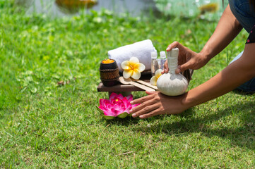 Spa massage wellness decorations setting on wood table. Thai spa massage traditional compress for...