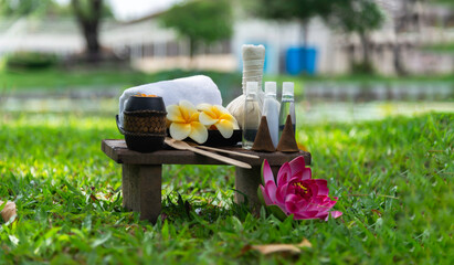 Spa massage wellness decorations setting on wood table. Thai spa massage traditional compress for...