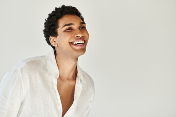merry alluring african american male model in white linen attire looking away on beige backdrop