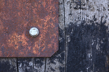 A close-up of weathered wood and corroded metal
