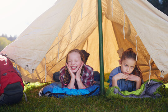 Kids, gen z and camping in tent in nature for holiday, adventure and sleeping in woods for vacation. Portrait, happiness and friends on field trip for school, children and bootcamp for girls. - Powered by Adobe
