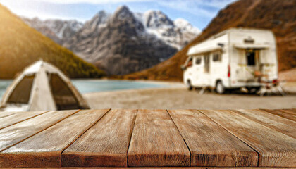 Beautiful camping travel picnic car empty wooden rustic table or product, beverage, food placement display with blurred natural background.
