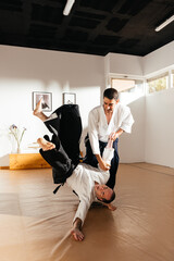 Aikido Practitioner Demonstrates Technique in Dojo During Training Session