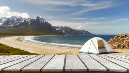 Wooden table in the blurred camping tent on the beach on a beautiful sunny day.Summer vacation,...