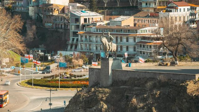 Tbilisi, Georgia. Statue Of King Vakhtang Gorgasali near Metekhi church. Traffic near Gorgasali monument. Georgian Capital Skyline Cityscape Time lapse timelapse. Elevated top Scenic View Famous
