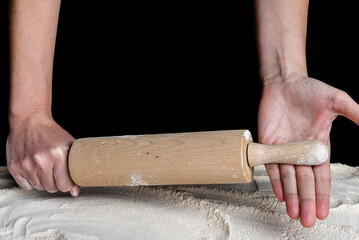 Angry woman hands with rolling pin above flour. Baking concept. - 783081217