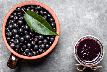 Aronia jam and fresh berry on stone table. - 783082481