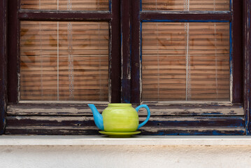 Teapot used as plant pot on window sill