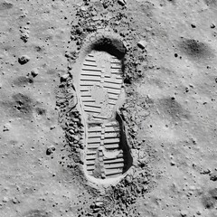 A close-up of a footprint on a rocky surface. The concept of exploration and adventure, as the footprint is on a moon-like surface, suggests that someone has ventured into the unknown