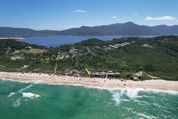 Mole beach aerial view, Florianopolis island, Santa Catarina. Conceicao Lake at background.