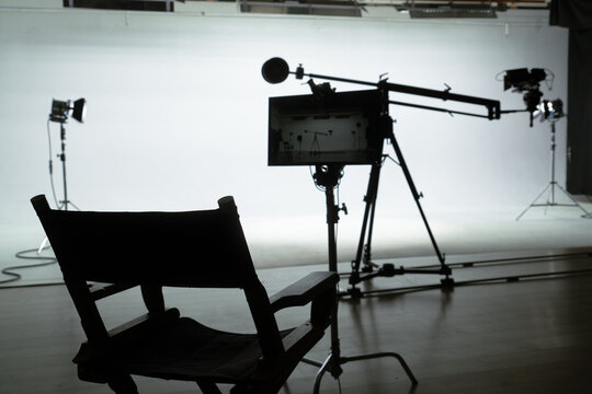 Silhouette of a Director's Chair in a Film Studio Backstage shot.