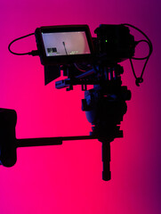 Cinematic Camera Silhouette Against Neon Glow - obrazy, fototapety, plakaty