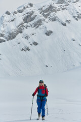 A Female Mountaineer Ascends the Alps with Backcountry Gear - 783093801