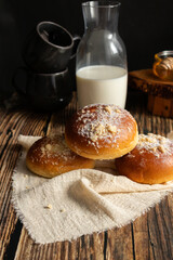Fresh rolls with milk. on a dark wooden background. morning