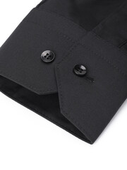 Close-up of a cuff of a black shirt with buttons on a white background