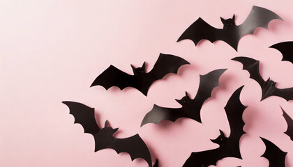 Halloween party decorations concept. Top panoramic view photo of bat silhouettes on isolated pastel pink background with copy space