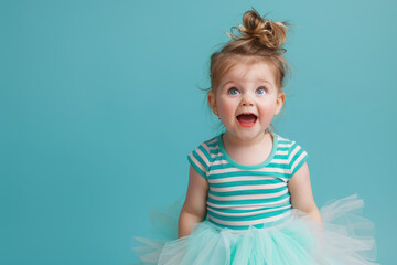 A cute little girl wearing colorful is standing on the right side of the picture, hands covering her mouth in surprise and joy expression with teal blue background