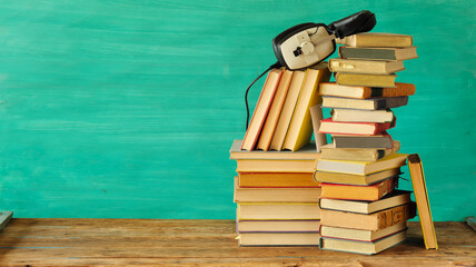 Large heap of books and heaphones, audio books concept, entertainment,education and e learning on...
