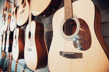 Group of classic musical guitar instruments . Side View of Guitar at Display Rack