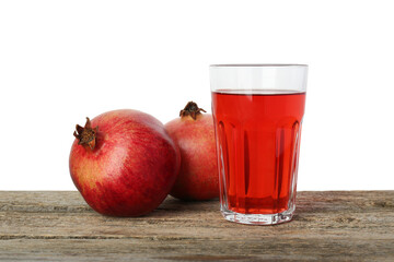 Refreshing pomegranate juice in glass and fruits on wooden table against white background