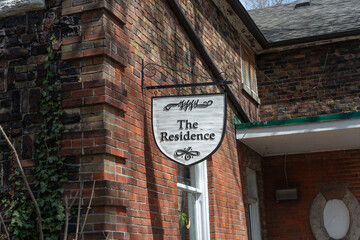 Fototapeta premium projecting sign outside The Residence at Riverdale Farm in Toronto, Canada