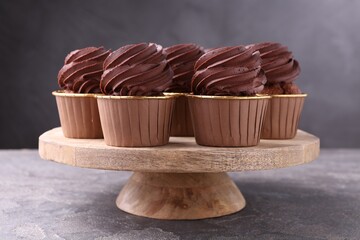 Delicious chocolate cupcakes on grey textured table