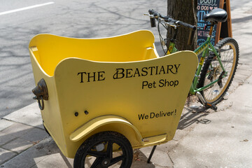 Fototapeta premium cute yellow cart of The Beastiary Pet Shop located near 570 Parliament Street in Toronto, Canada