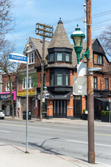 Fototapeta premium exterior building and sign of L'avenue, a restaurant (and nearby businesses) located at 583 Parliament Street in Toronto, Canada