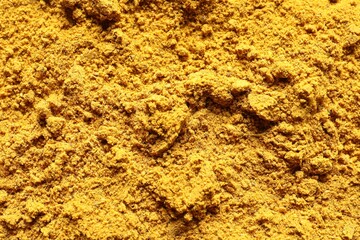 Dry curry powder as background, top view