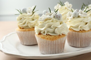 Tasty Easter cupcakes with vanilla cream on table, closeup