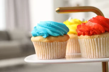 Gordijnen Delicious cupcakes with bright cream on dessert stand indoors, closeup © New Africa