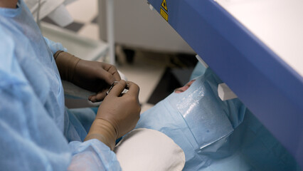 Ophthalmology room for eye surgeries. ophthalmic surgery. Surgeon's hands in gloves performing...