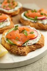 Fotobehang Tasty canapes with salmon, cucumber, radish and cream cheese on table, closeup © New Africa