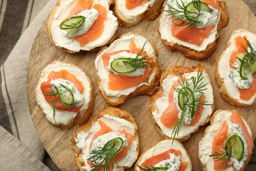 Gordijnen Tasty canapes with salmon, cucumber, cream cheese and dill on table, top view © New Africa
