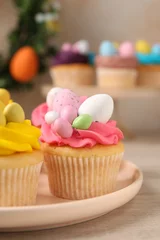 Deurstickers Tasty decorated Easter cupcakes on wooden table, closeup © New Africa