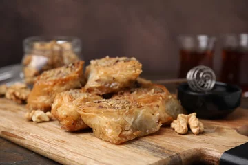 Foto op Canvas Eastern sweets. Pieces of tasty baklava on wooden table, closeup © New Africa