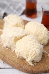 Eastern sweets. Tasty Iranian pashmak on white wooden table, closeup